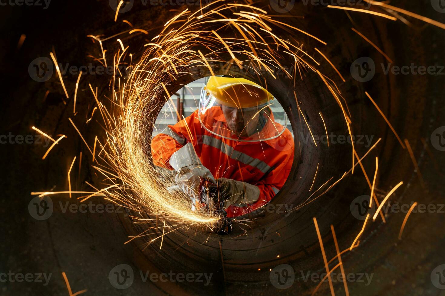 An Electric wheel grinding at Industrial worker cutting metal pipe with many sharp sparks photo