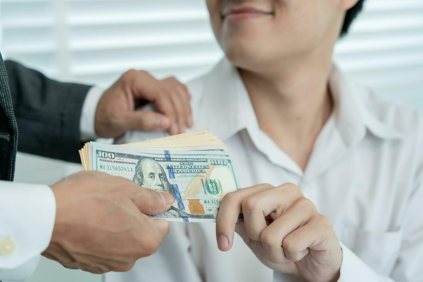 Businessmen receive salary or bonuses from management or Boss. Company give rewards to encourage work. Smiling businessman enjoying a reward at the desk in the office. photo