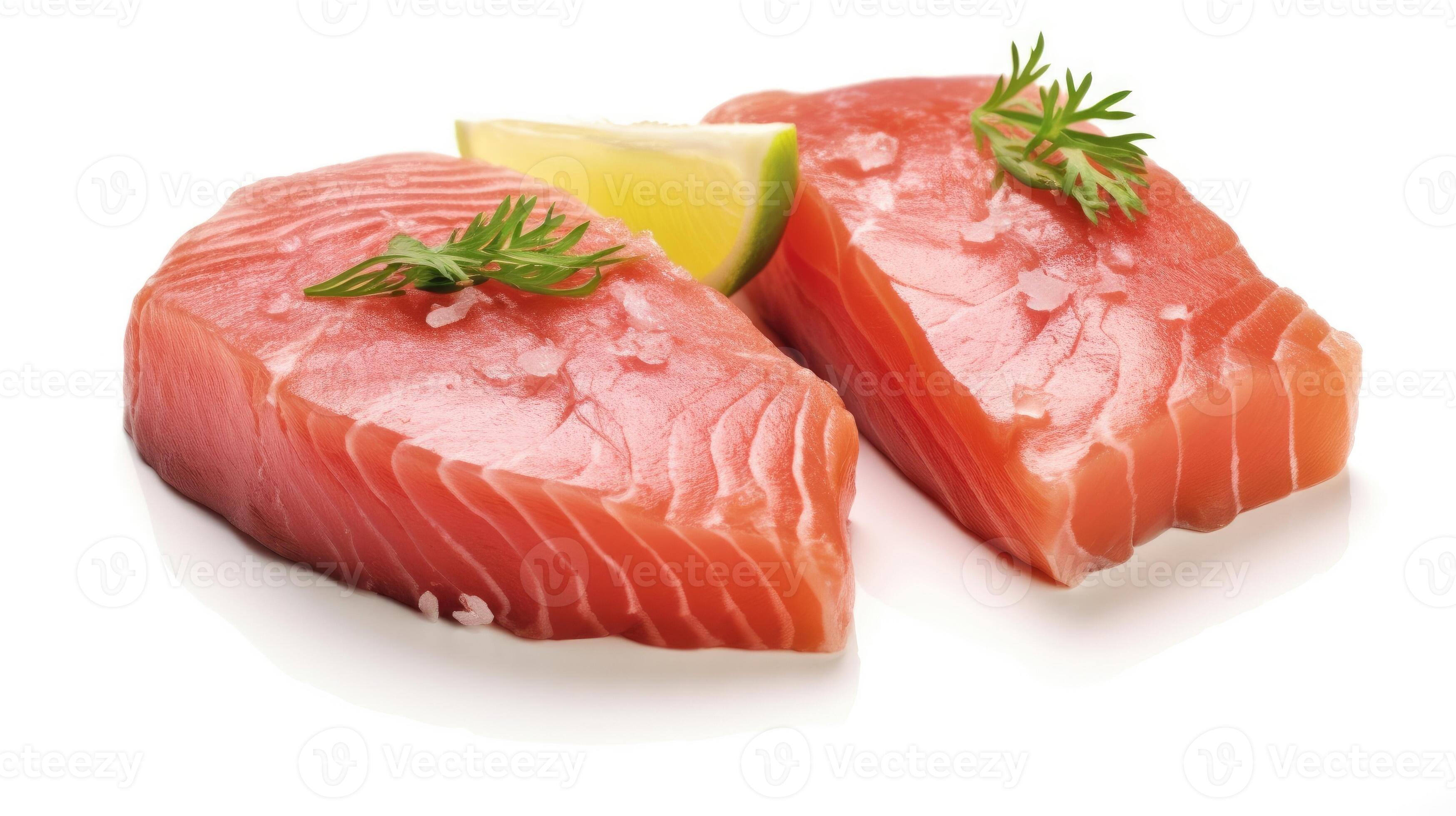 Fresh tuna fish fillet steaks garnished with parsley isolated on white