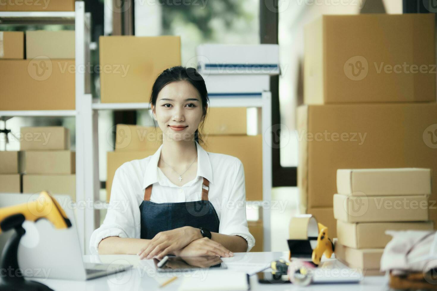 Young business woman working online e-commerce shopping at her shop. photo