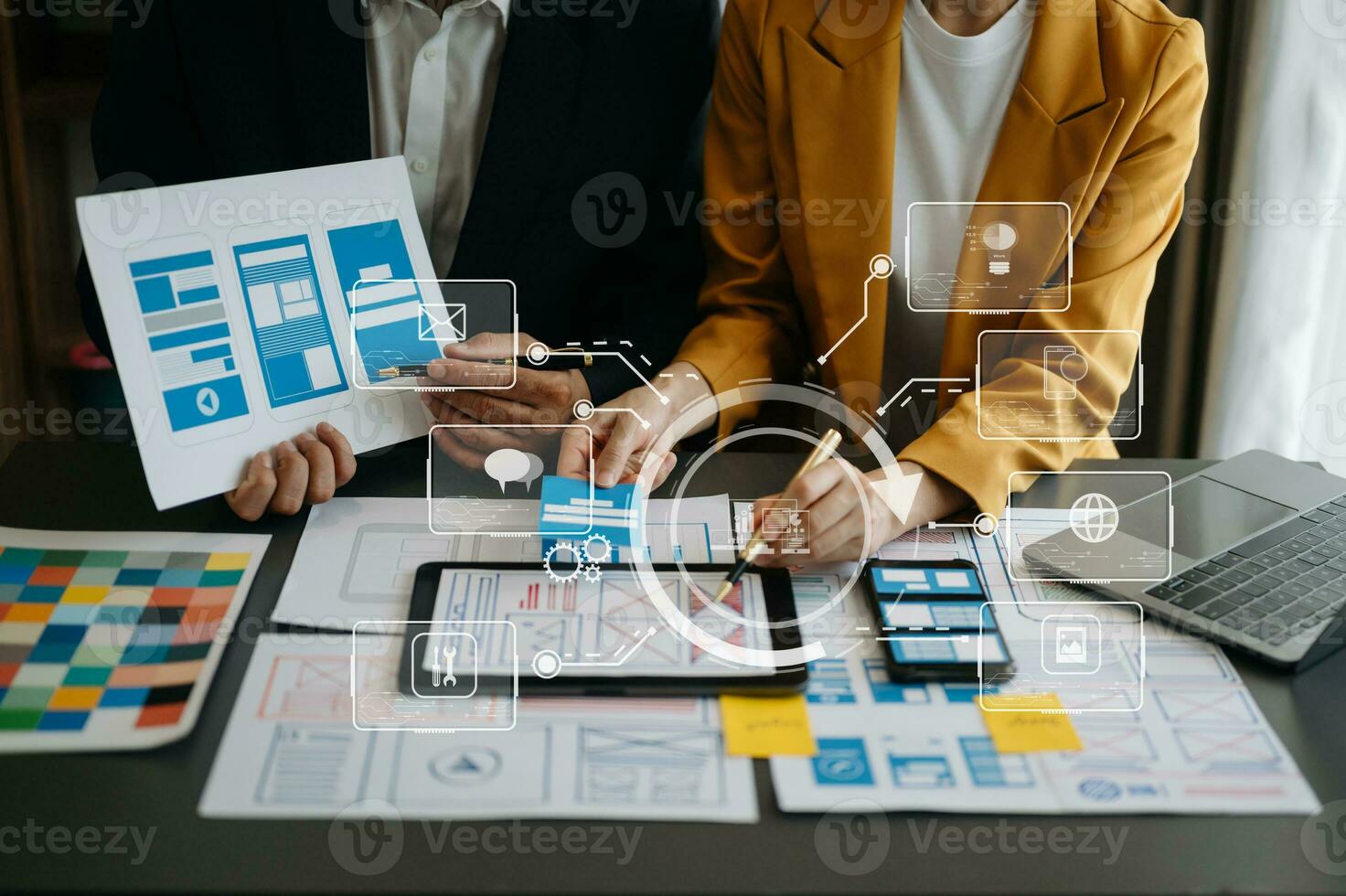 Close up view of UI developer team brainstorming on their project with laptop, smartphone and digital tablet. Creative digital development agency. with virtual icons photo