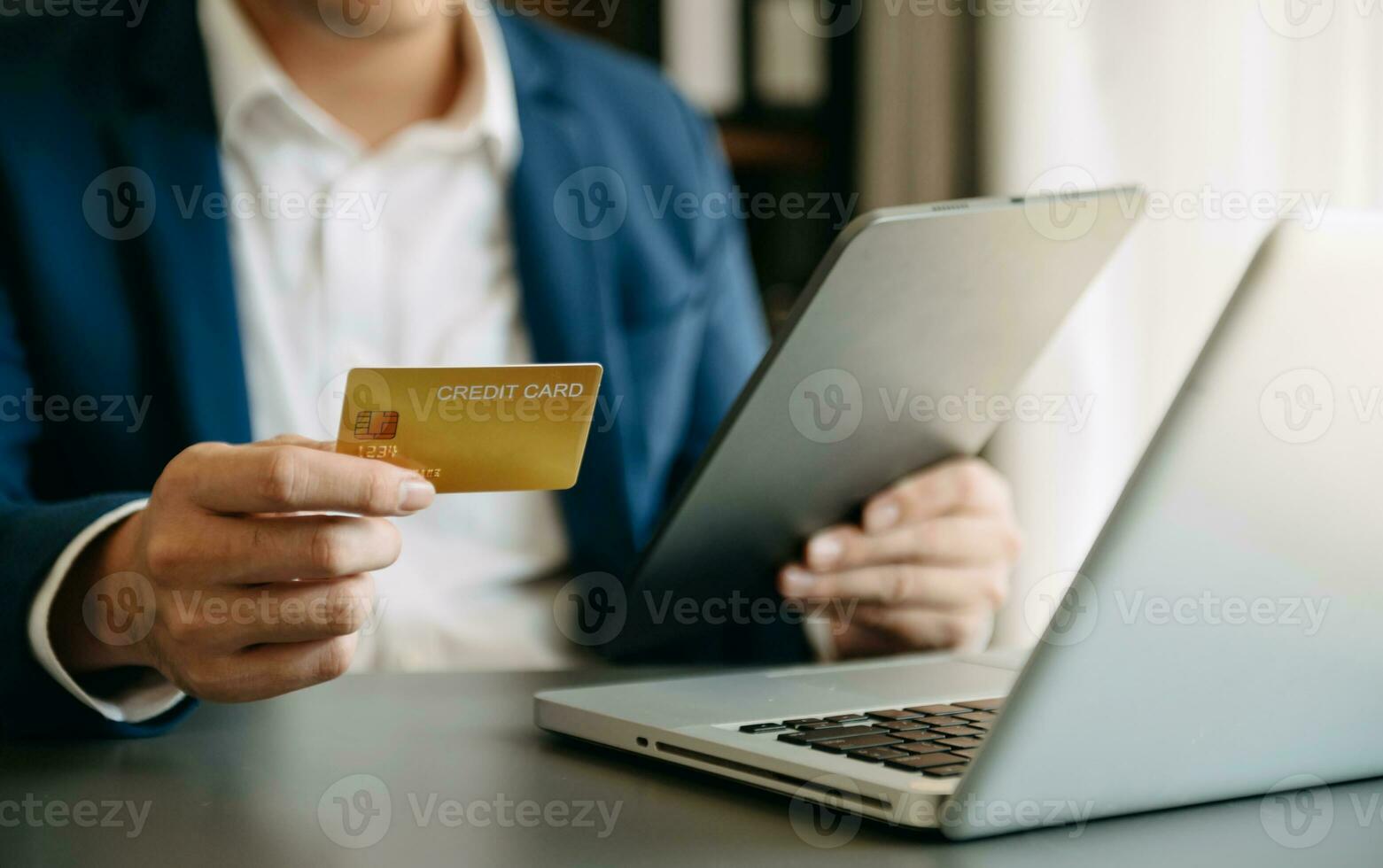 Man using smart phone for mobile payments online shopping,omni channel,sitting on table,virtual icons graphics interface screen photo