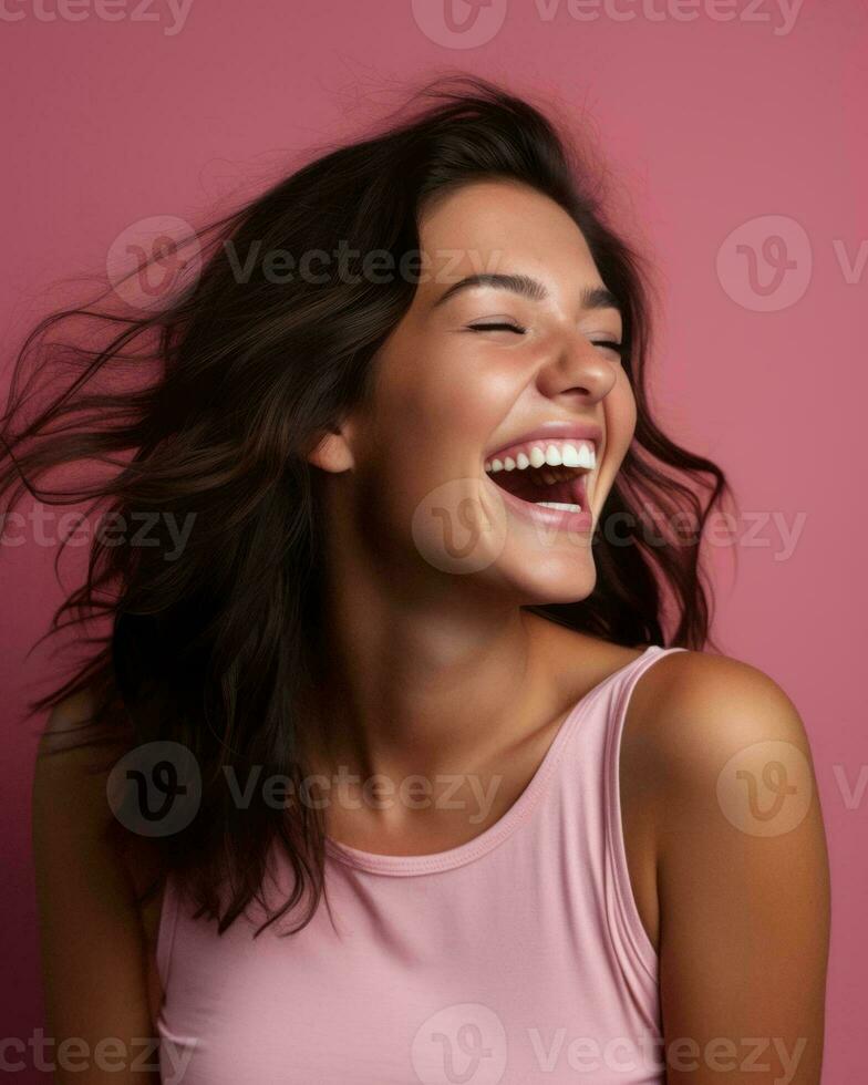 portrait of smiling young woman laughing on pink background stock photo generative AI