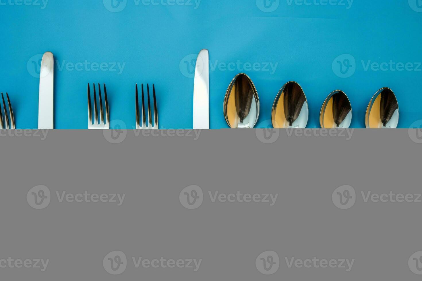 a group of silverware on a blue background generative ai photo