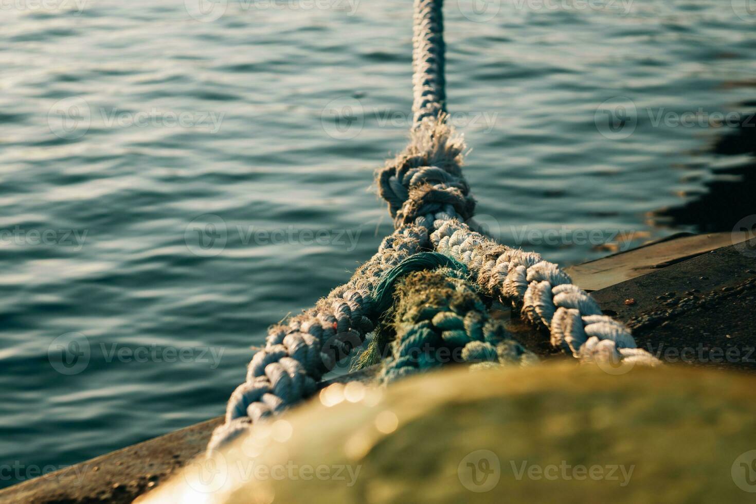 Powerful bitts on the pier on which several marine ropes are fixed. Fastening to which ships are attached near the shore photo