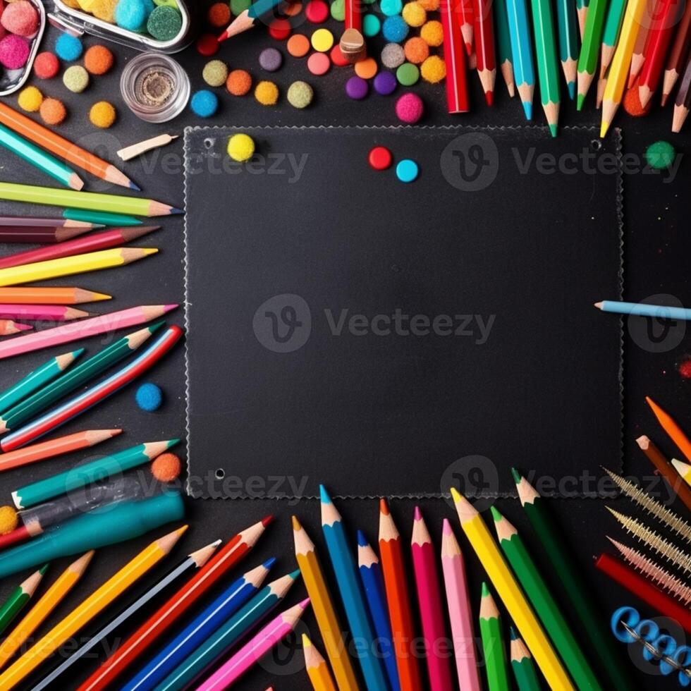 a close up of a blackboard surrounded by colored pencils and markers