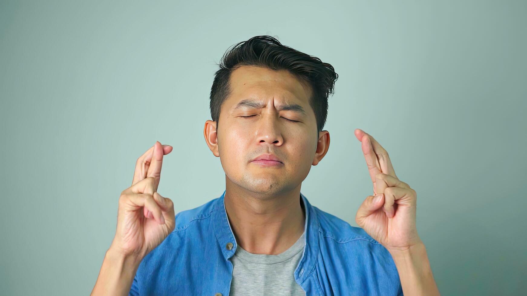 Asian man handsome wearing asking to be quiet with finger on lips. Silence and secret concept. photo