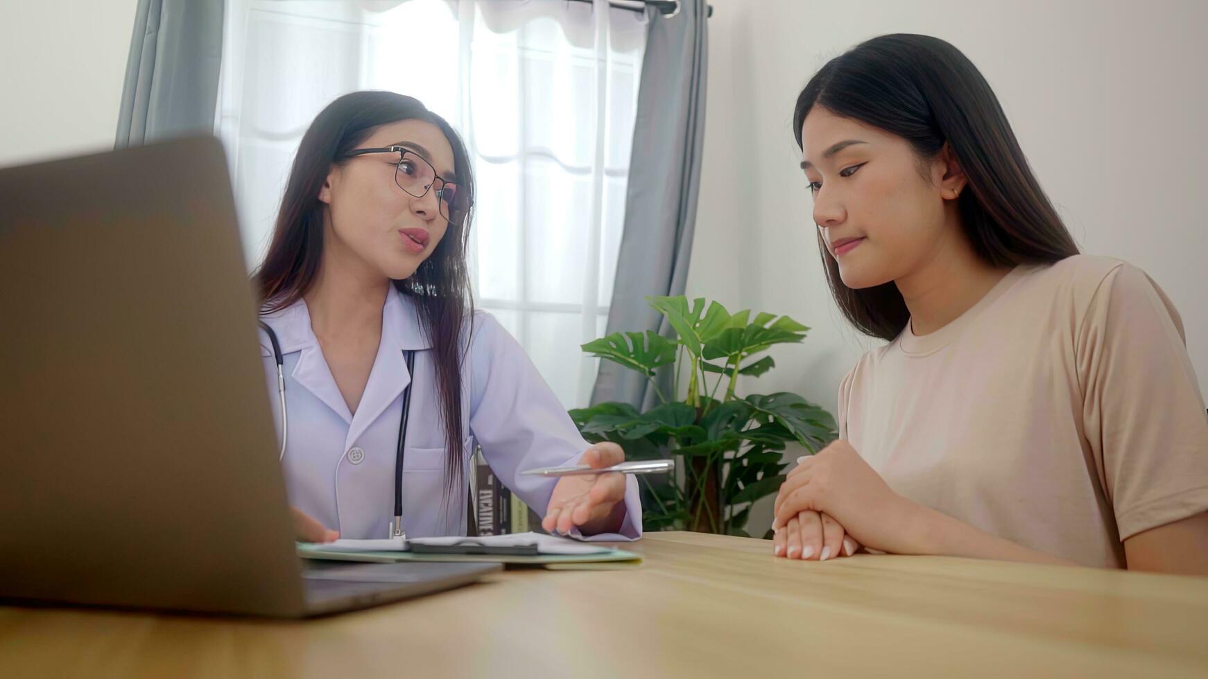 Asian woman doctor encourage young woman in a hospital. health check consept. photo