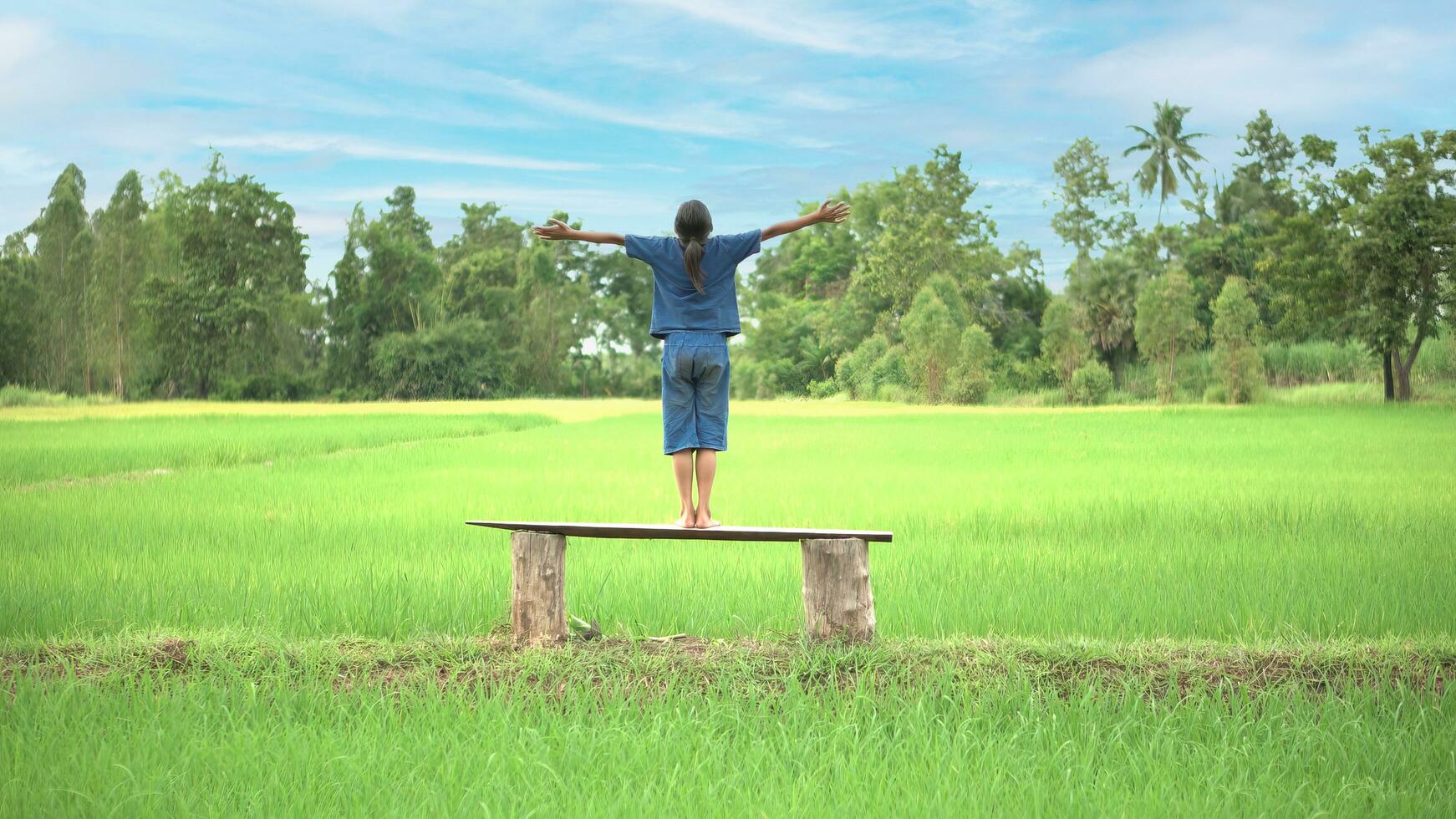 Happy little girl in rice field, countryside of Thailand. photo