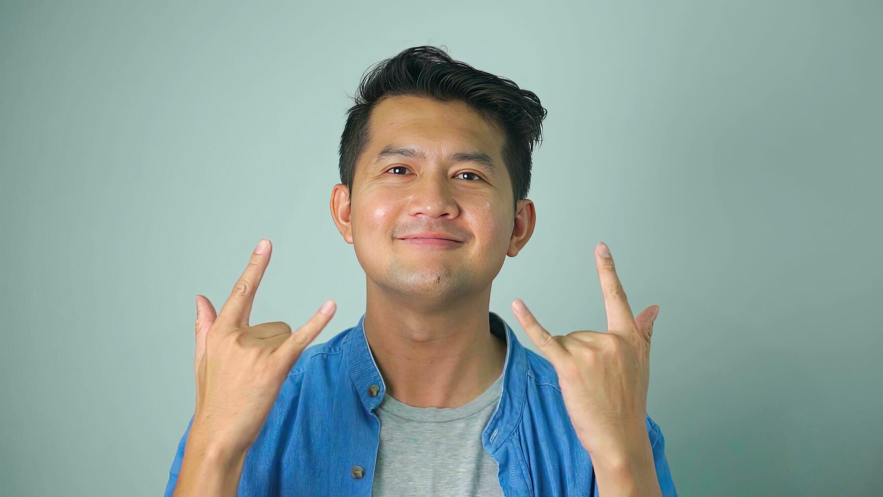 Asian man happy laughing standing on white background. photo