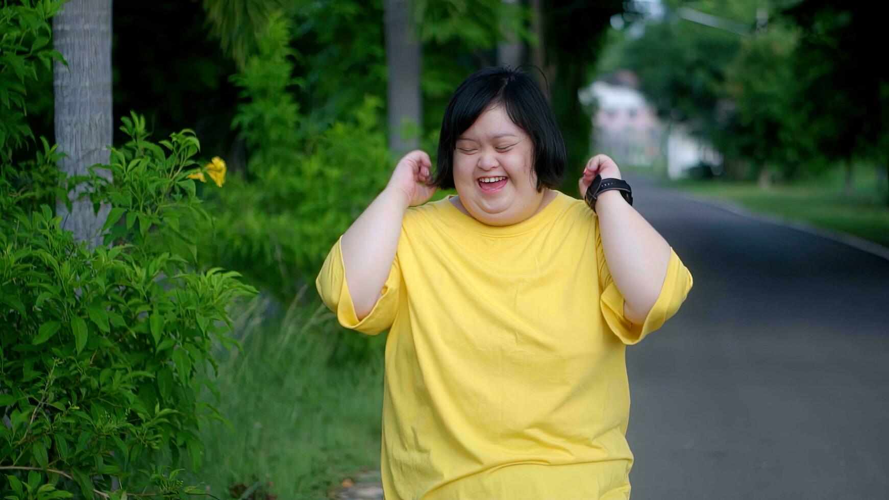 Asian woman with Down's syndrome is happy to imagine her crossing the finish line. photo