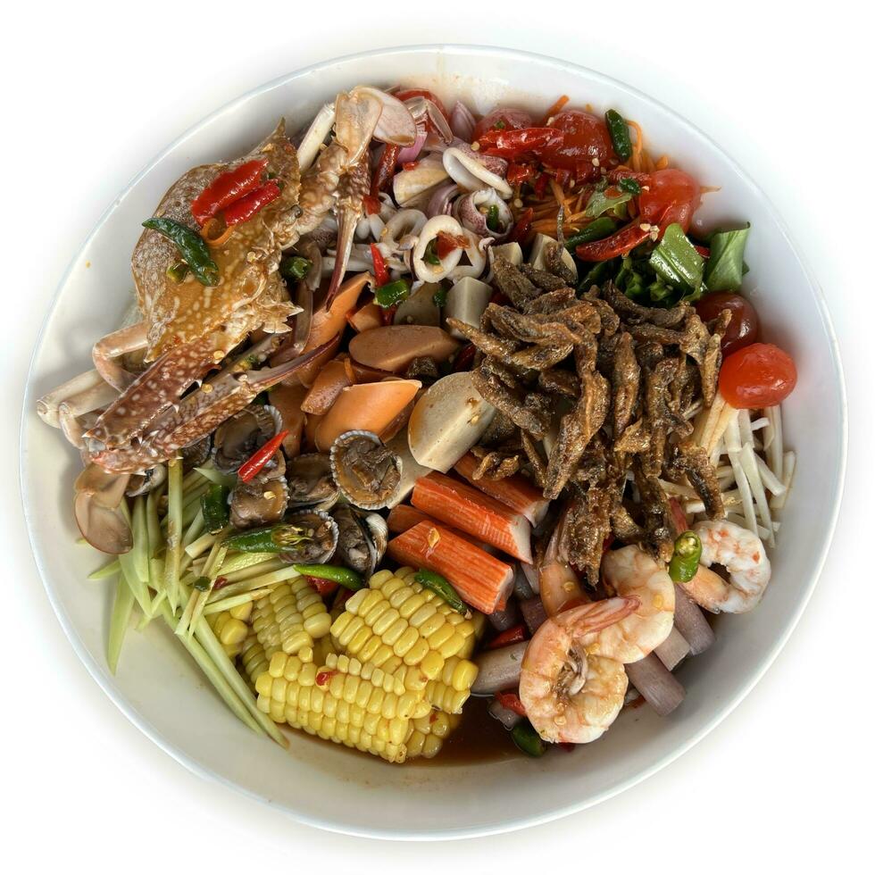 Thai spicy salad with seafood in white bowl on white background. photo