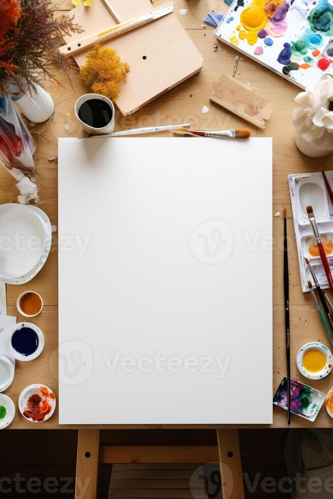 Artist's workspace with blank canvas and art supplies photo