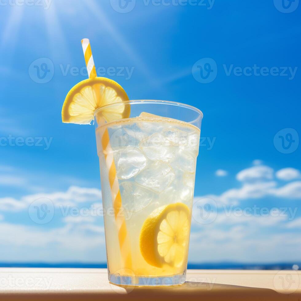 Bright Summer Image of Iced Lemonade in Glass with Lemon Slice and Straw photo