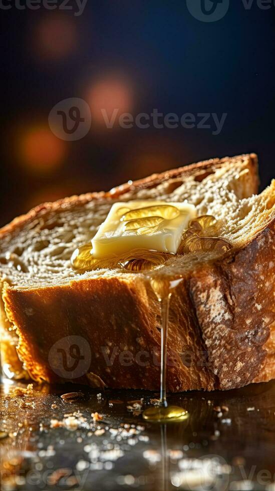 A slice of bread with butter and honey dripping down the side photo