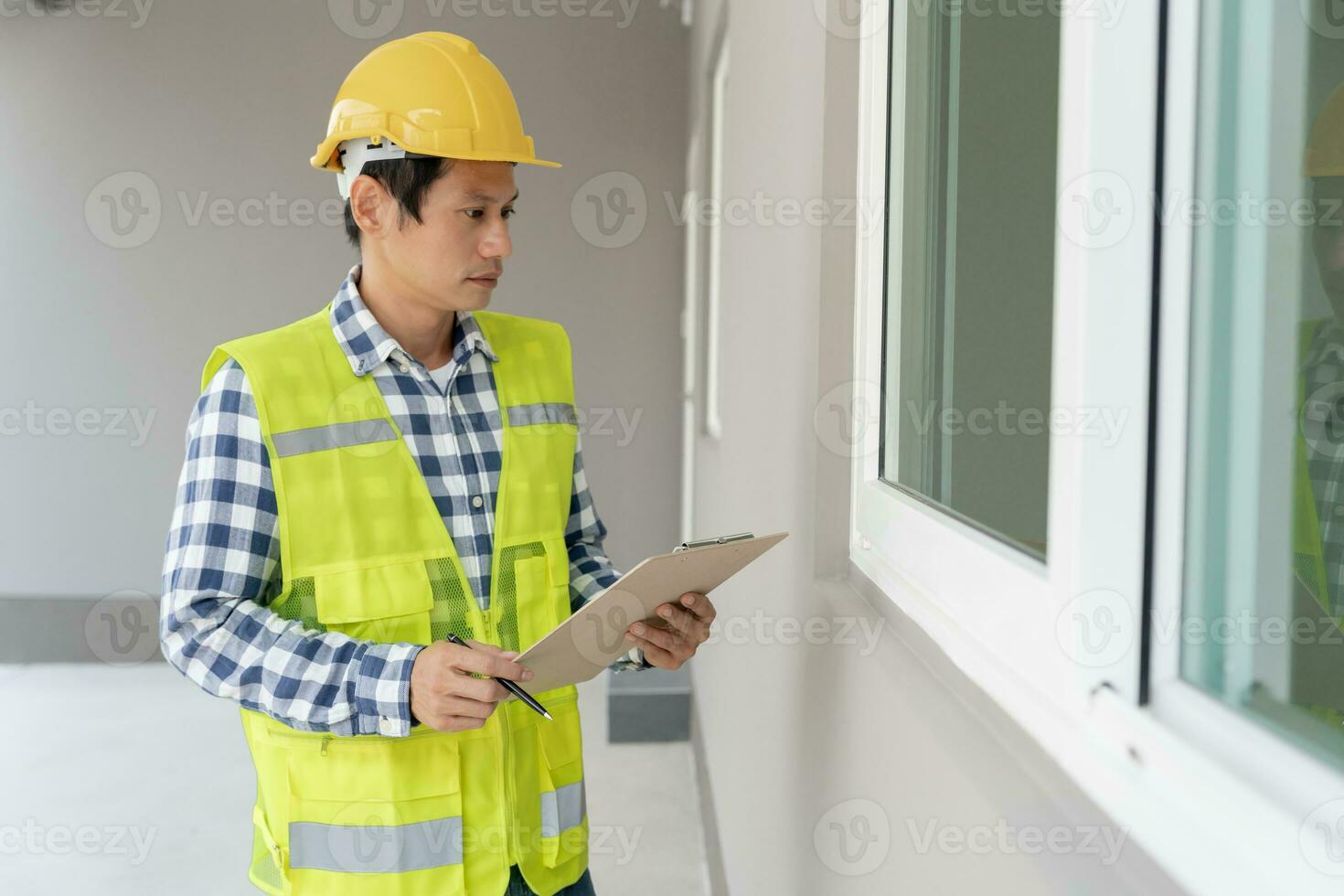 inspector or engineer is inspecting construction and quality assurance new house using a checklist. Engineers or architects or contactor work to build the house before handing it over to the homeowner photo