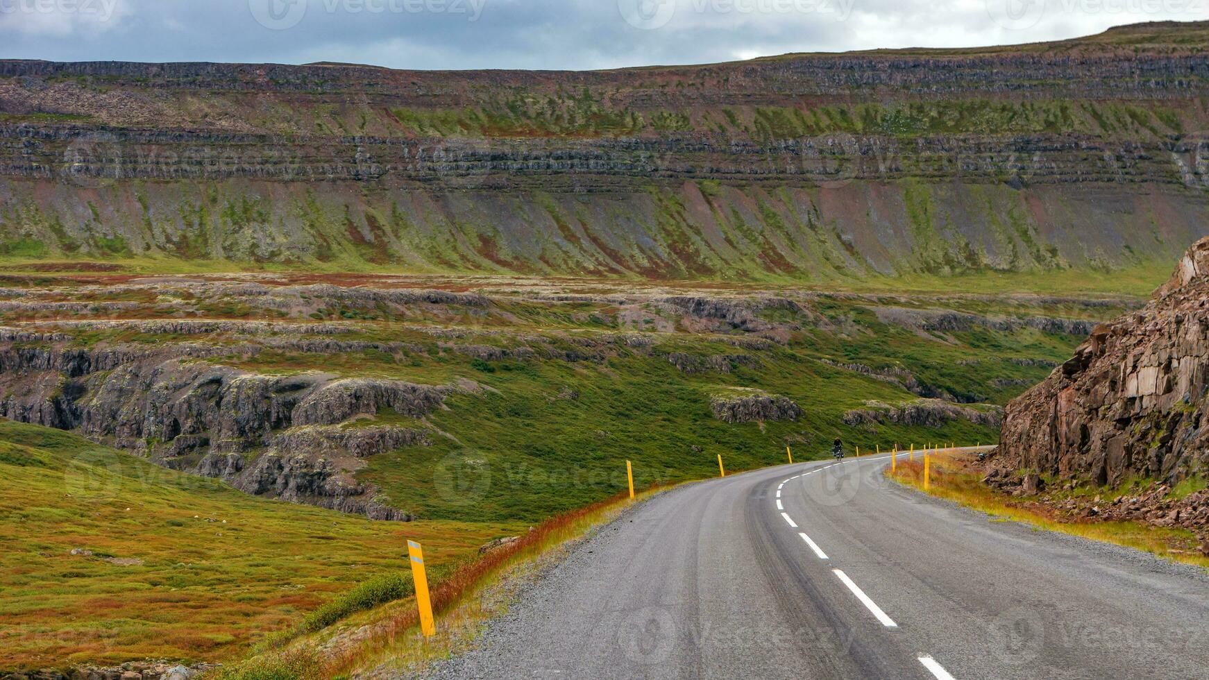 Panoramic over a paved road and Icelandic colorful and wild landscape with fjords at summer time, West Iceland photo