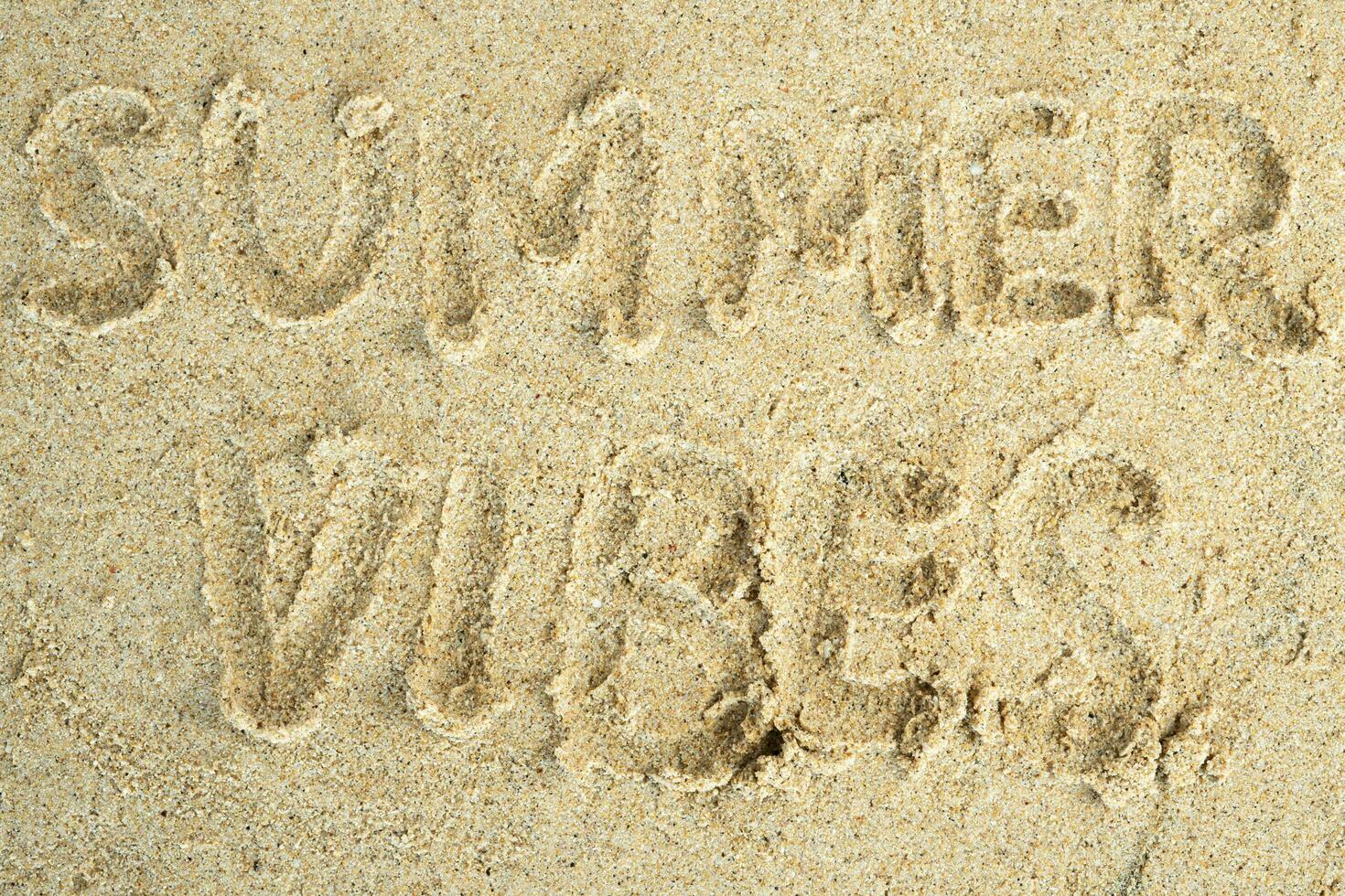 summer vibes drawn on beach sand photo