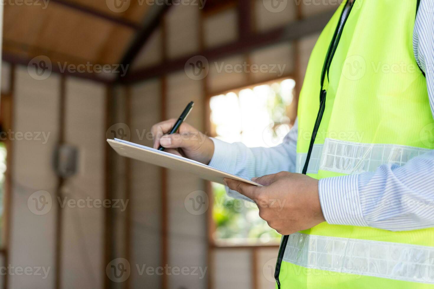 inspector or engineer is inspecting construction and quality assurance new house using a checklist. Engineers or architects or contactor work to build the house before handing it over to the homeowner photo