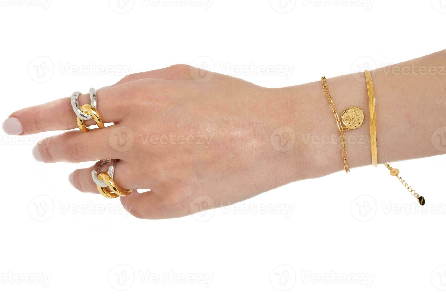 Woman hand wearing Butterfly and Snake Chain bracelets and Interlocked Golden and Silver Rings set against a white background. Beautiful valentine's gift. photo