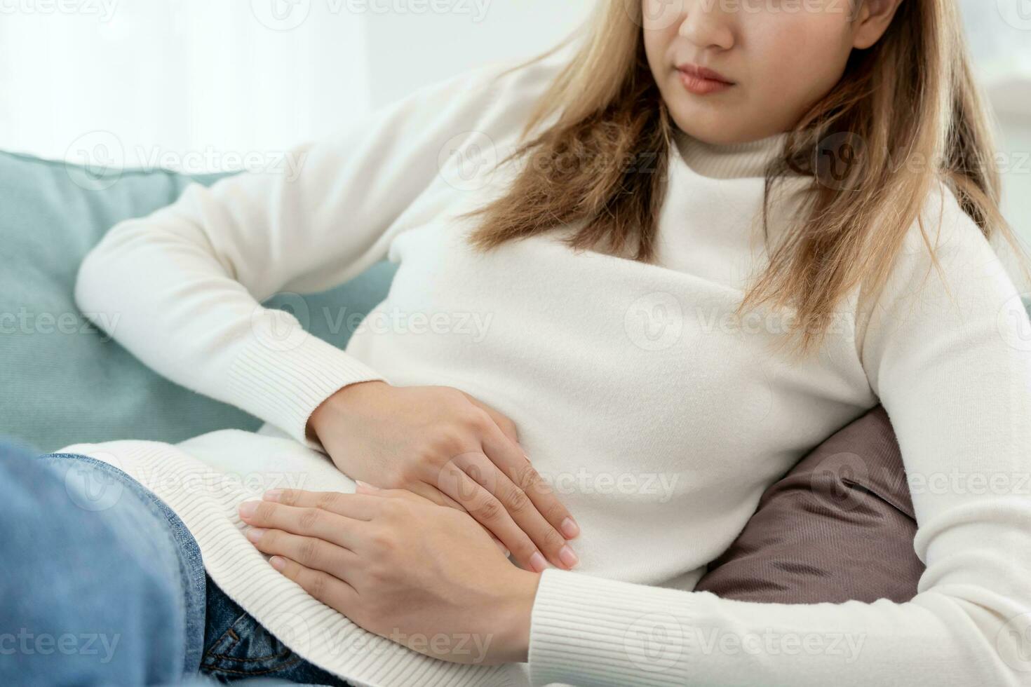 stomach ache. Asian women have abdominal pain, indigestion, gastritis, menstrual cramps, flatulence, diarrhea, distention, colon cancer, belly inflammation problem, suffer food poisoning, abdomen photo