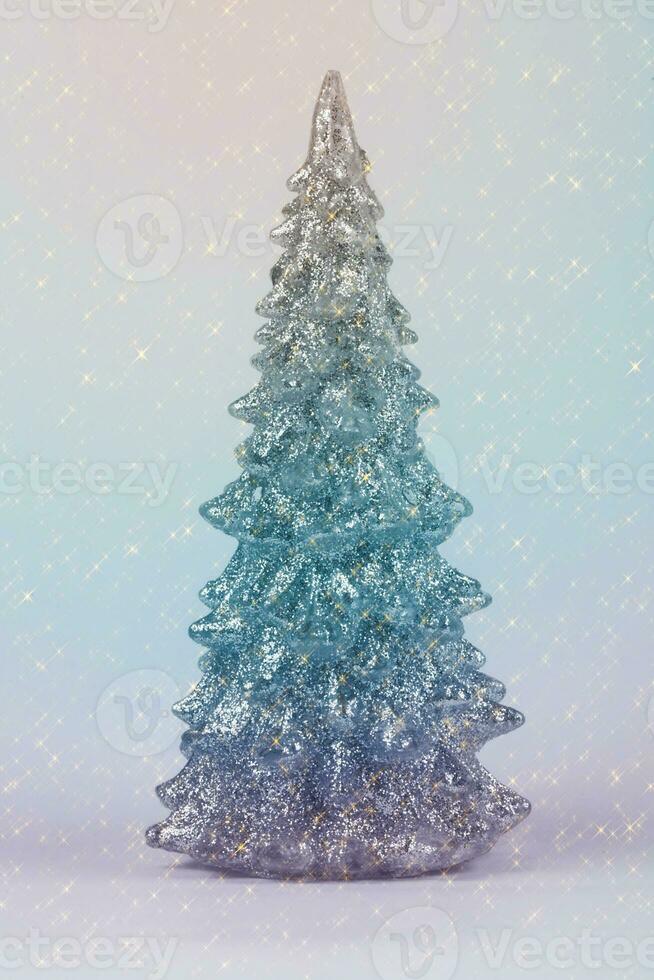 Christmas composition. Multicolored Christmas tree on a gray background with festive sparkles. Happy Holidays. Minimal new year concept. photo