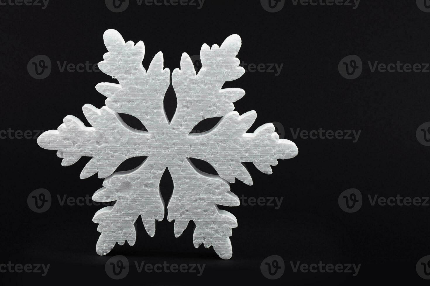 Festive Christmas background. black background large white snowflake. photo