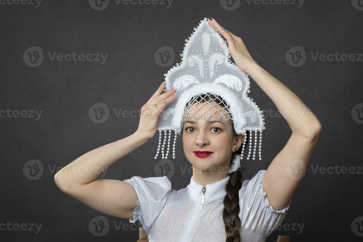 Snow Maiden. Winter portrait of a beautiful young woman in a winter crown. photo