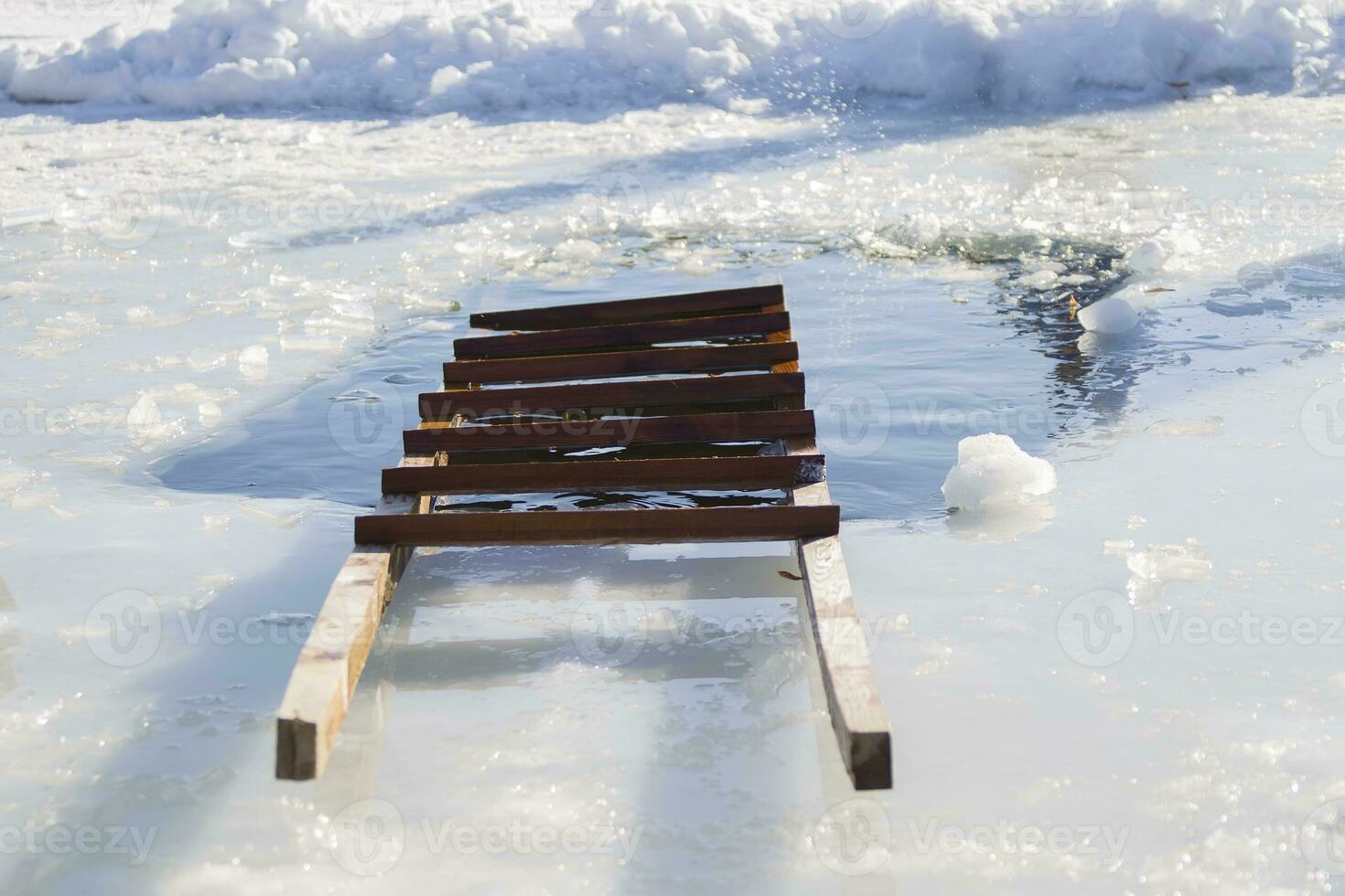 The feast of the baptism of Jesus. Ladder and baptismal ice-hole. photo