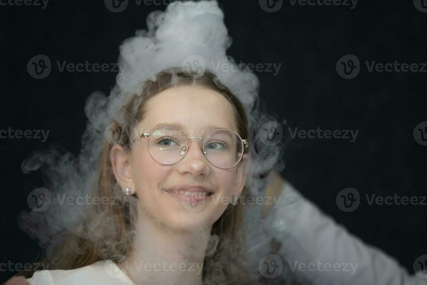 The child is a participant in scientific experiments. Girl in liquid nitrogen smoke. photo