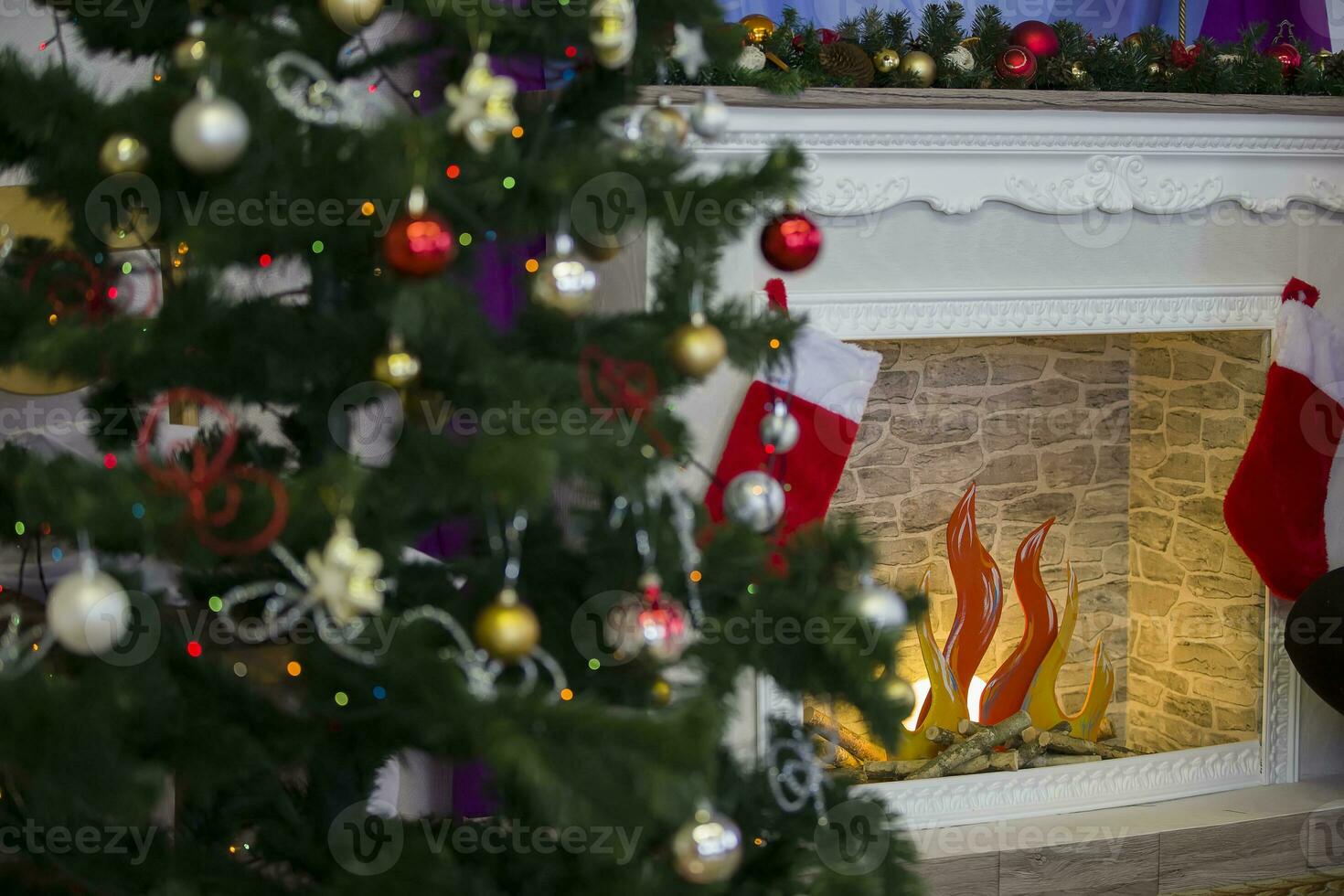 Fragment of a Christmas tree with toys on the background of an artificial fireplace.Christmas background photo