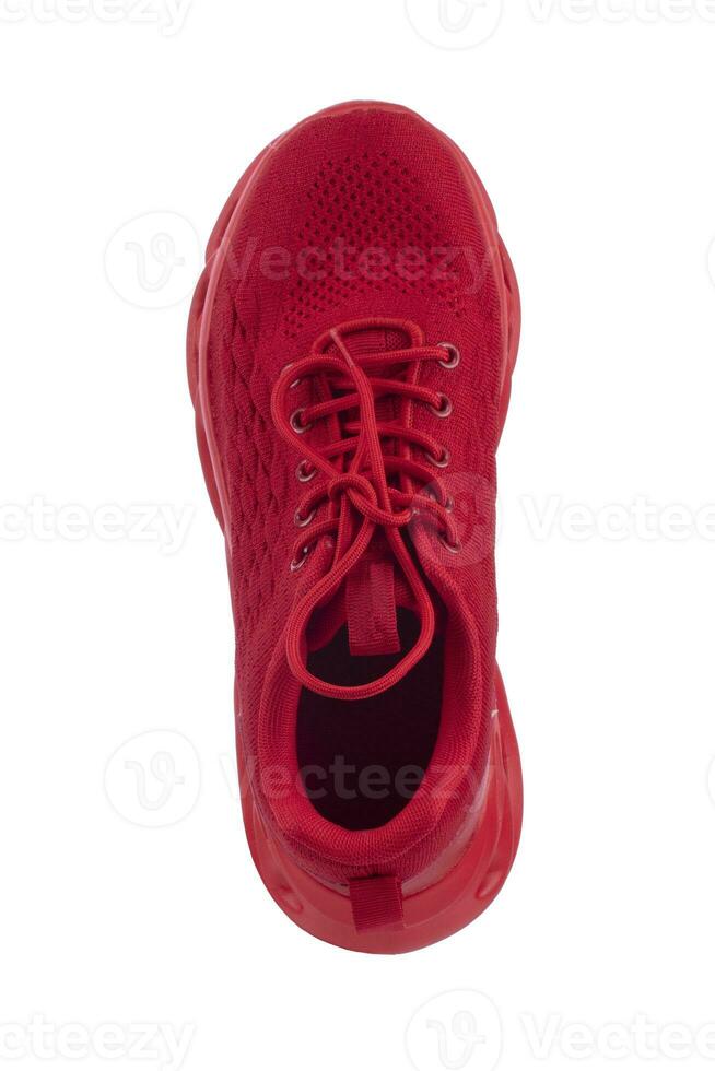 Red sneaker made of fabric on a white background. Sport shoes. photo
