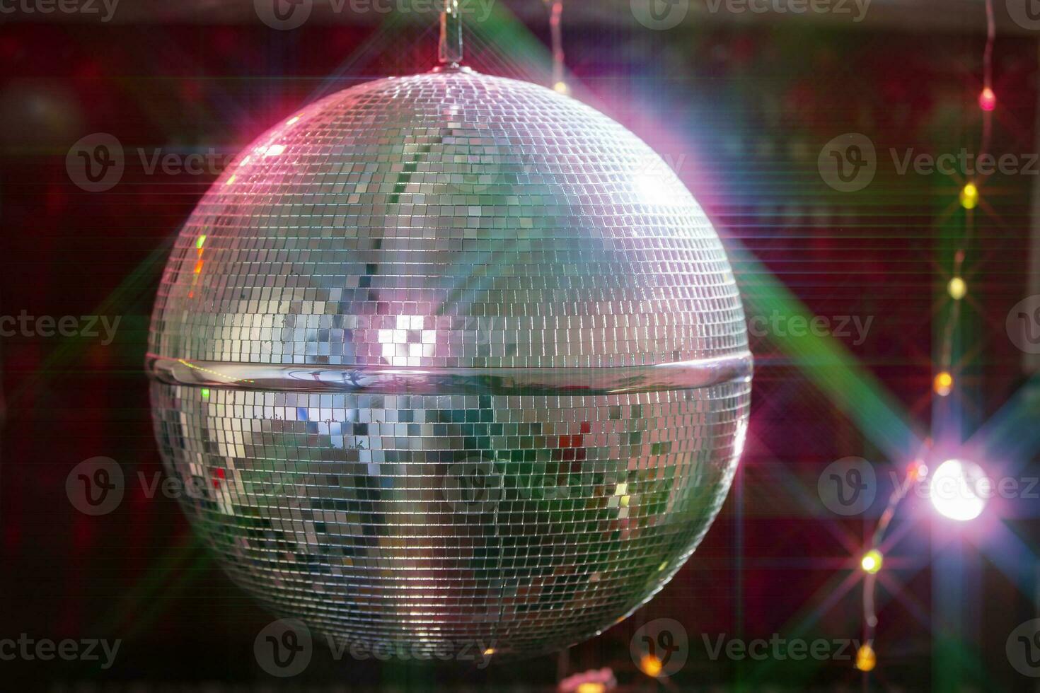 Disco ball with bright beams, night party background photo. photo