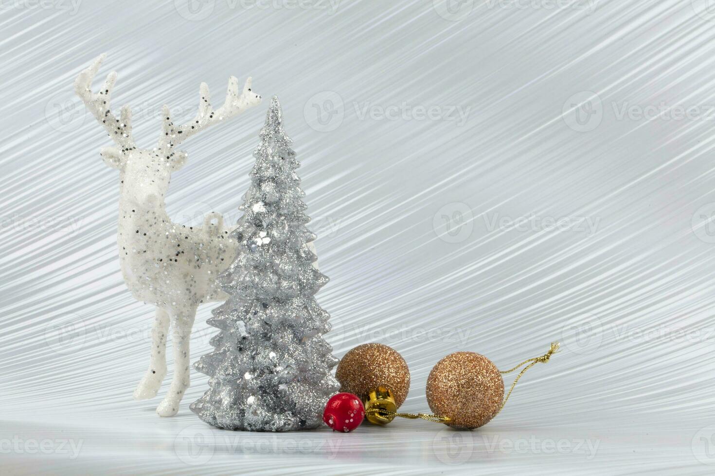 Christmas or New Year background with silver snowy tree and golden transitional decoration, deer. Bright festive background. photo