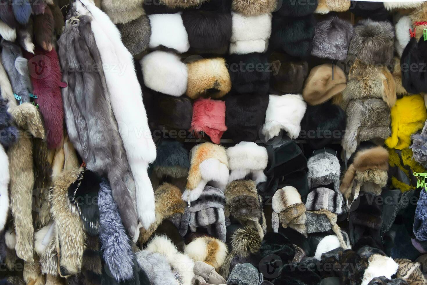 Natural fur and hats are sold on the market. Fur products. photo