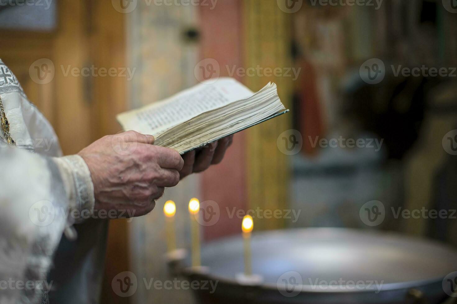 The hands of the priest hold the bible. Orthodox father photo