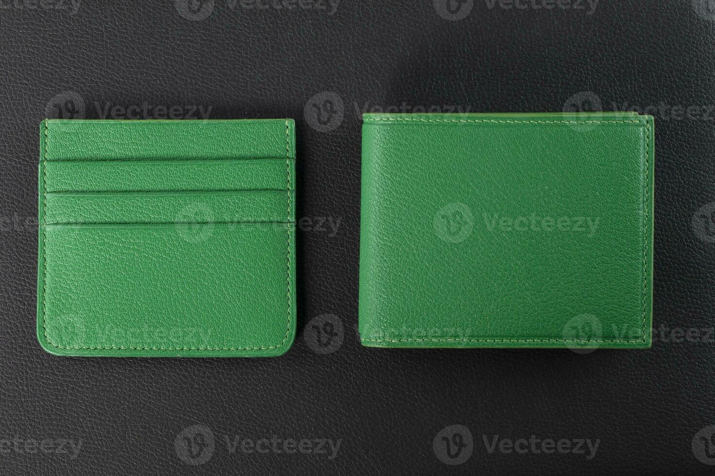 Leather products. Wallet business card holder made of green leather on a black background. photo