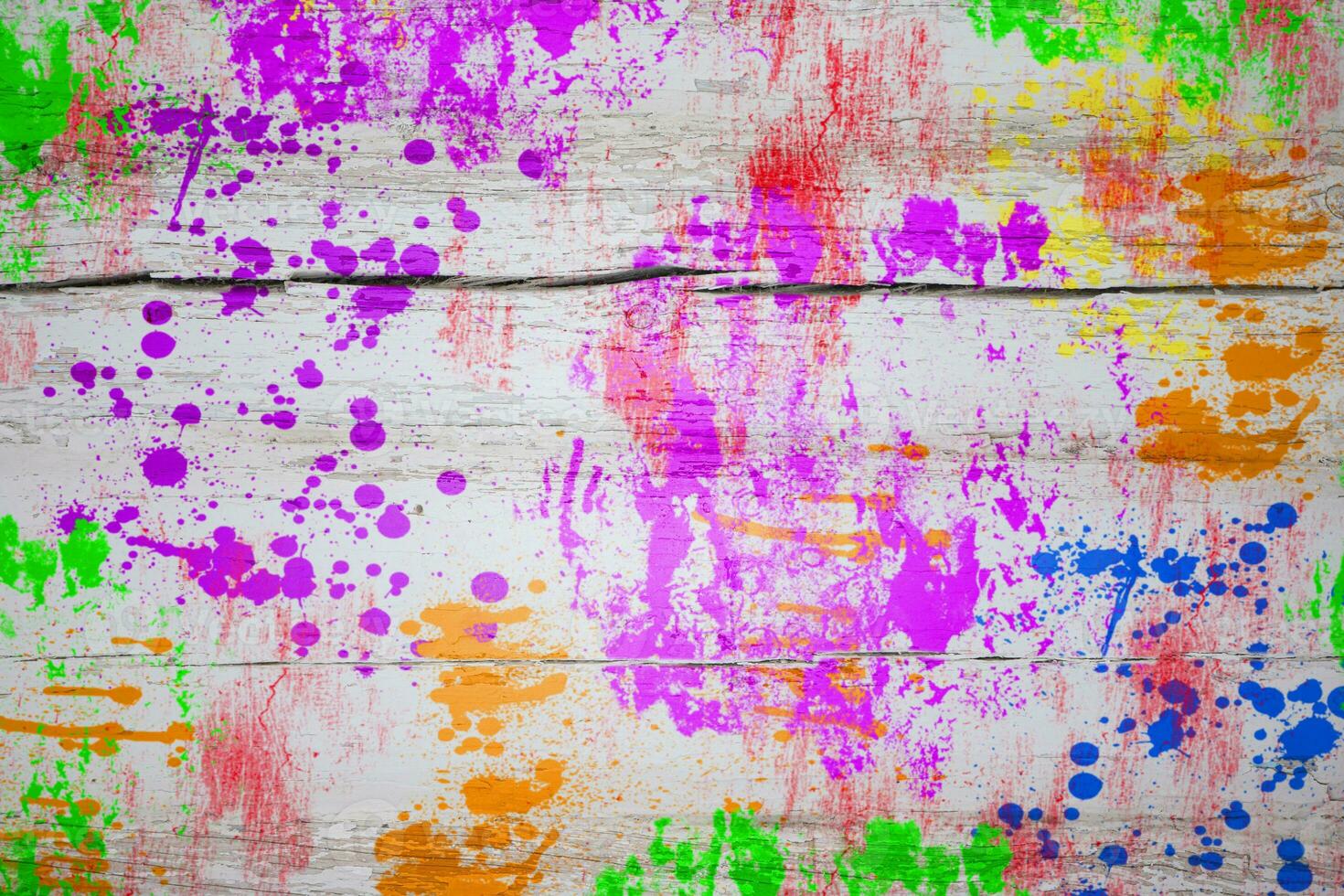 Multicolored paint stains on a wooden board. Bright colorful background. photo