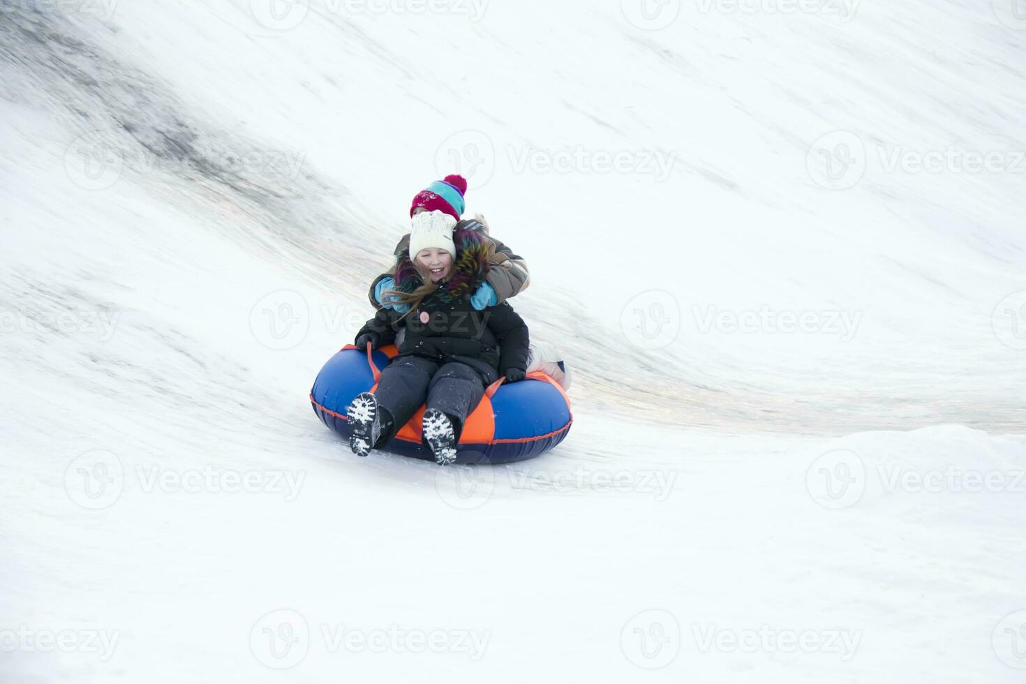 .Child sledding cheesecake.Kids are sleeping on toboggan photo