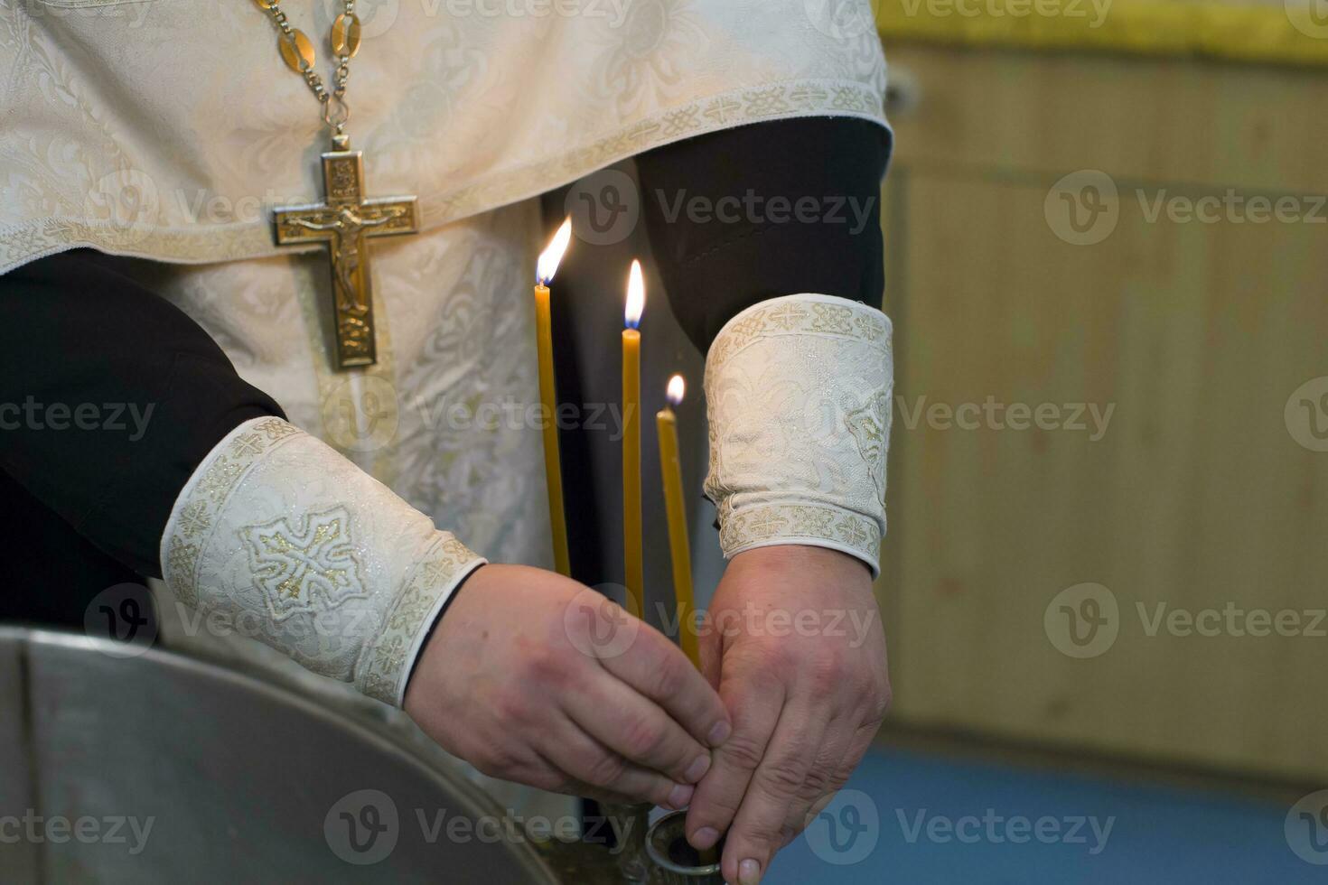 The rite of baptism. Priest prepare to baptize the child. Font for taking faith.The hands of the priest near the Epiphany bath photo