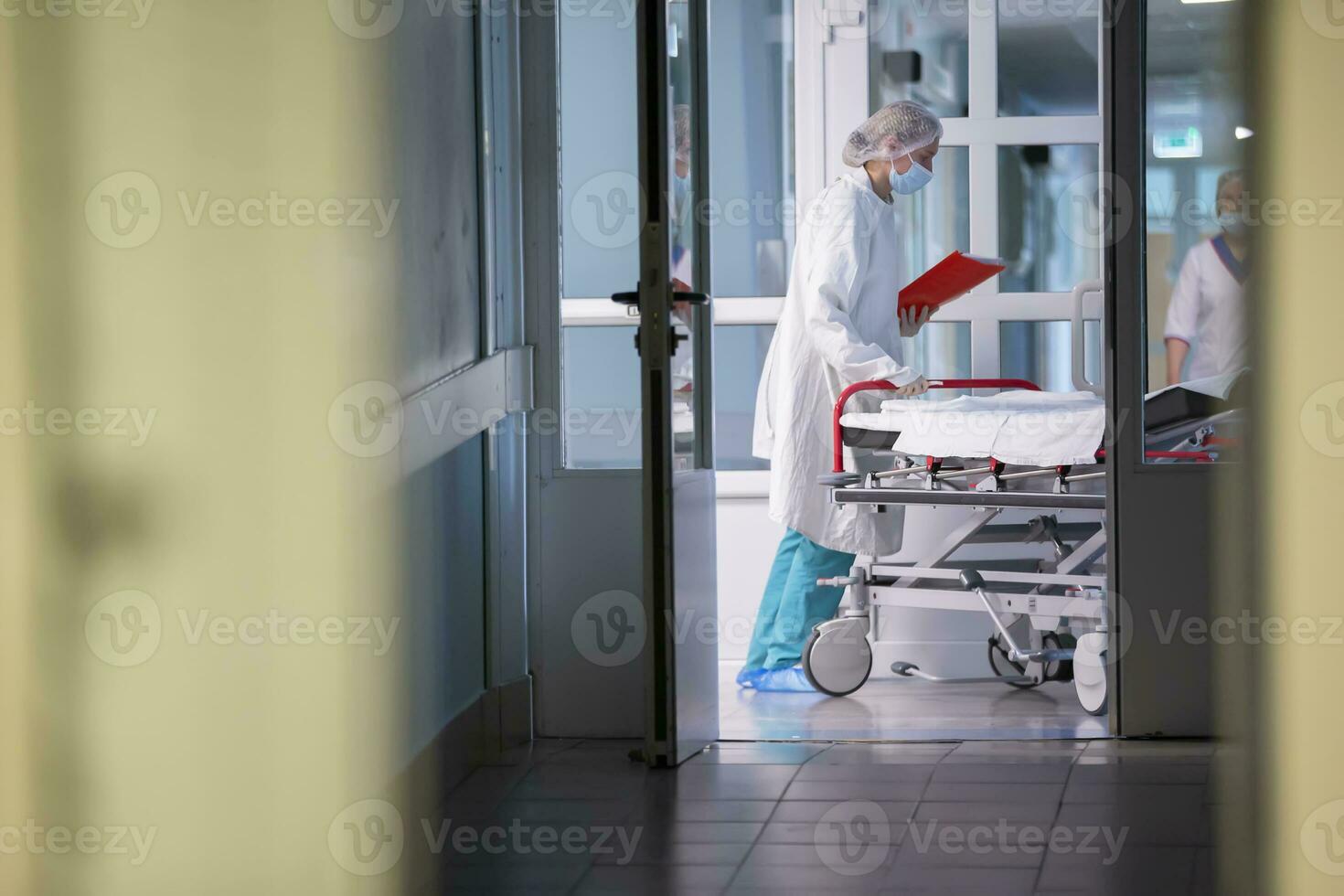 A nurse pushes a gurney with a stretcher in the hospital corridor.Hospital corridor. photo