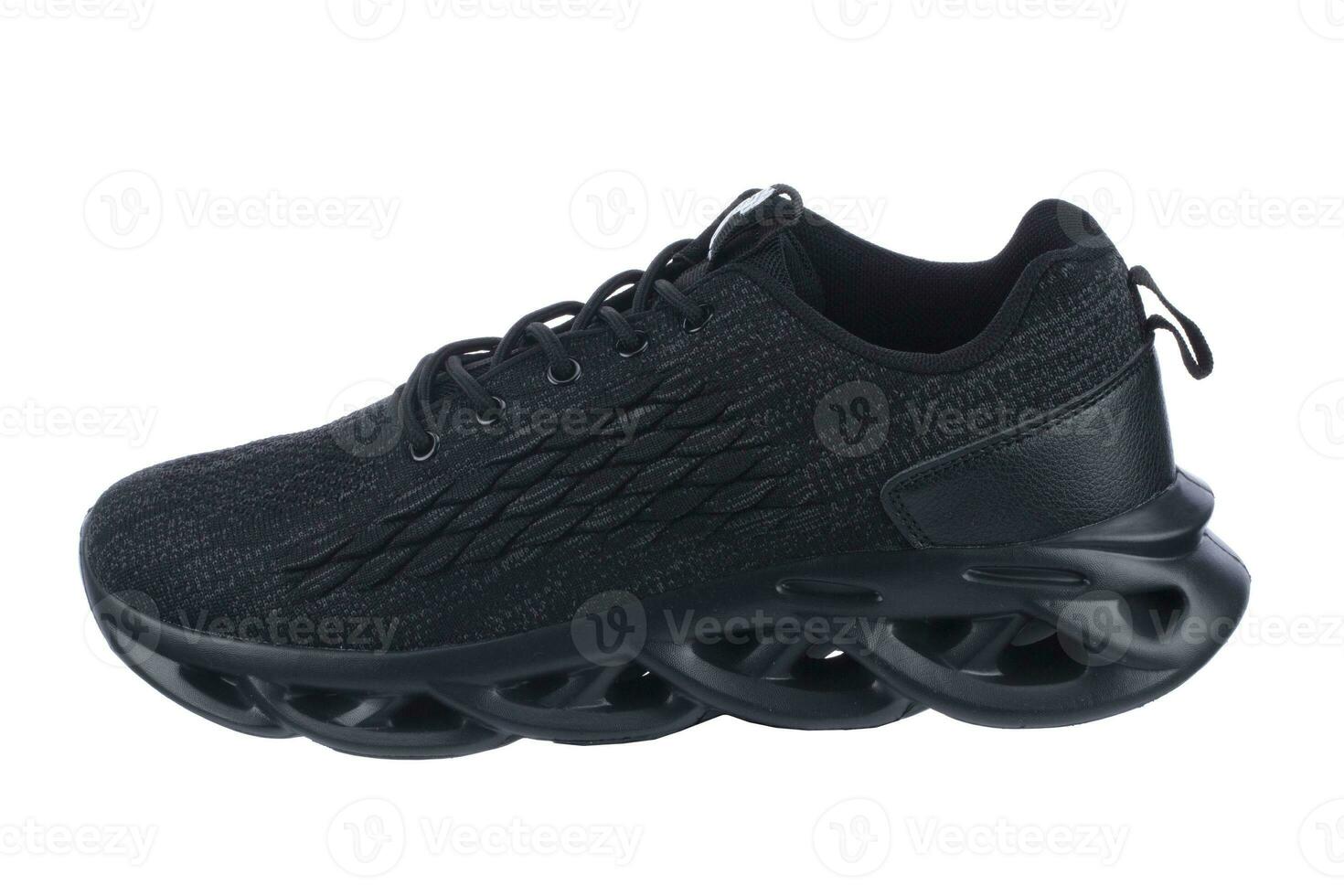 Sneaker one made of black fabric with lacing on a white background. photo