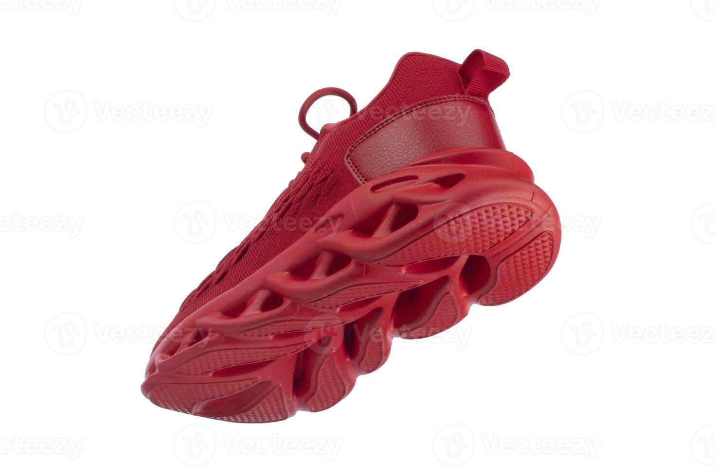 Flying red rag sneaker with a corrugated sole on a white background. Sport shoes. photo