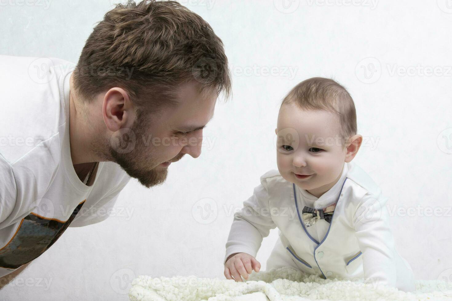 Father is talking to a cute baby. Young parent. photo
