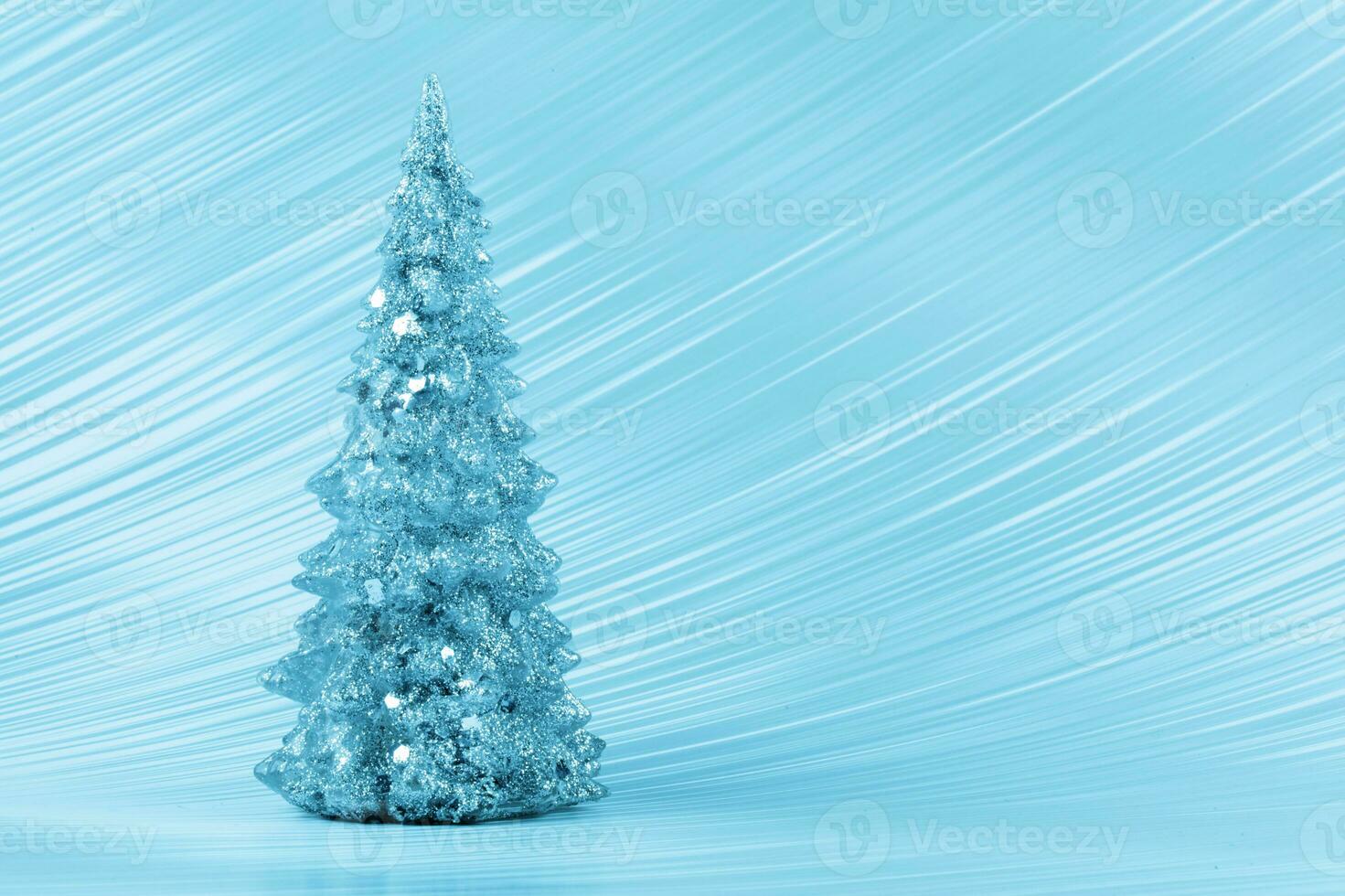 Christmas composition. Blue Christmas tree on a blue background. Happy Holidays. Minimal new year concept. photo