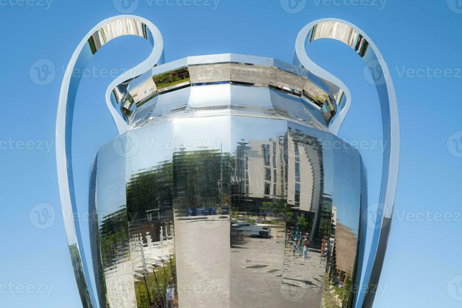 a large mirror award cup on the background of the sky photo