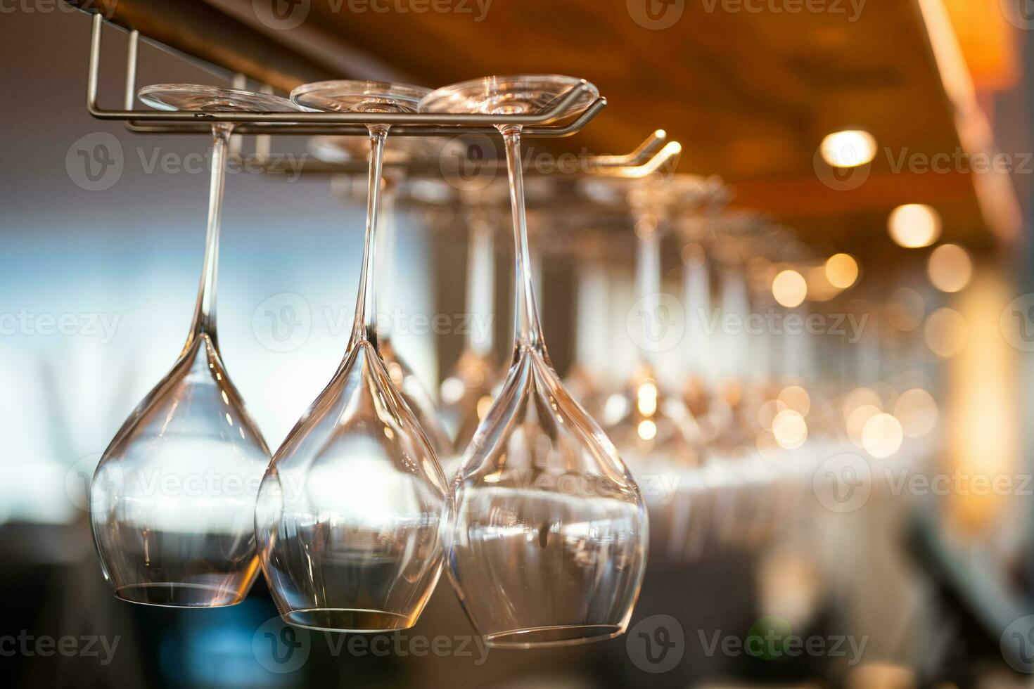 empty clean glass glasses for alcoholic drinks in a restaurant on a bar counter photo