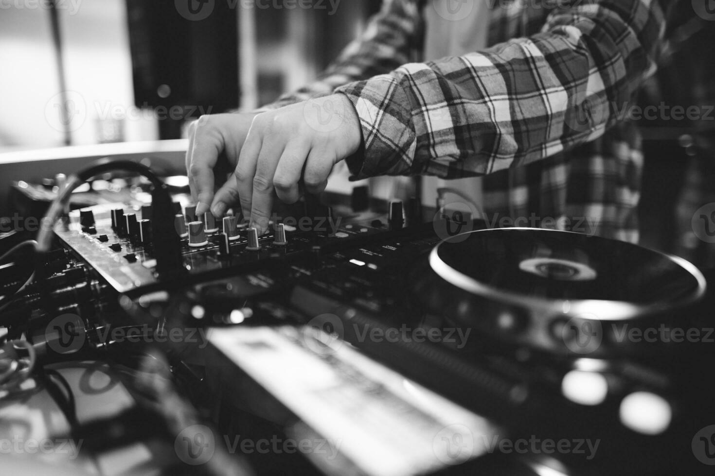 a DJ plays music on a controller at a party photo