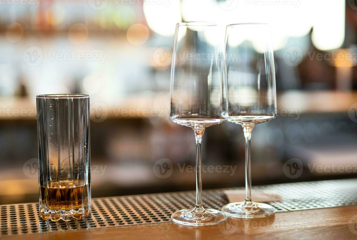 empty clean glass glasses for alcoholic drinks in a restaurant on a bar counter photo