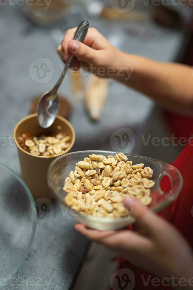 the confectioner sprinkles nuts on the dessert photo